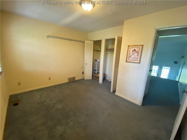 unfurnished bedroom featuring dark colored carpet