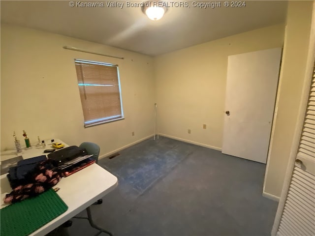 unfurnished office with dark colored carpet