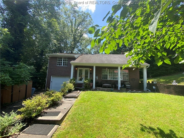 view of front of property with a porch, a garage, and a front lawn