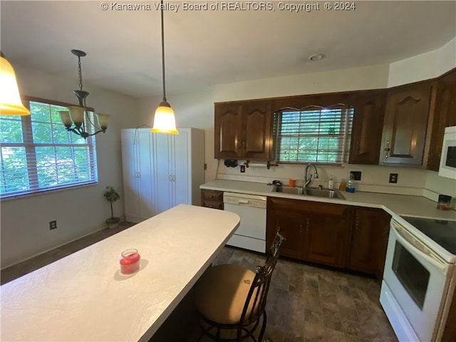 kitchen featuring white appliances, sink, hanging light fixtures, a notable chandelier, and dark brown cabinetry