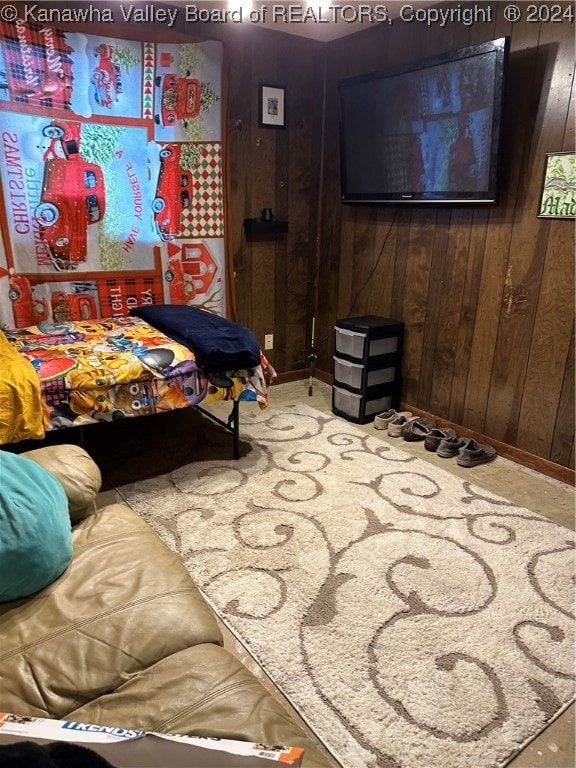 bedroom featuring wooden walls