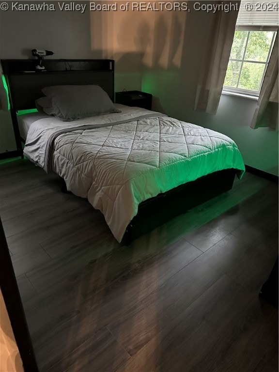 bedroom with hardwood / wood-style flooring