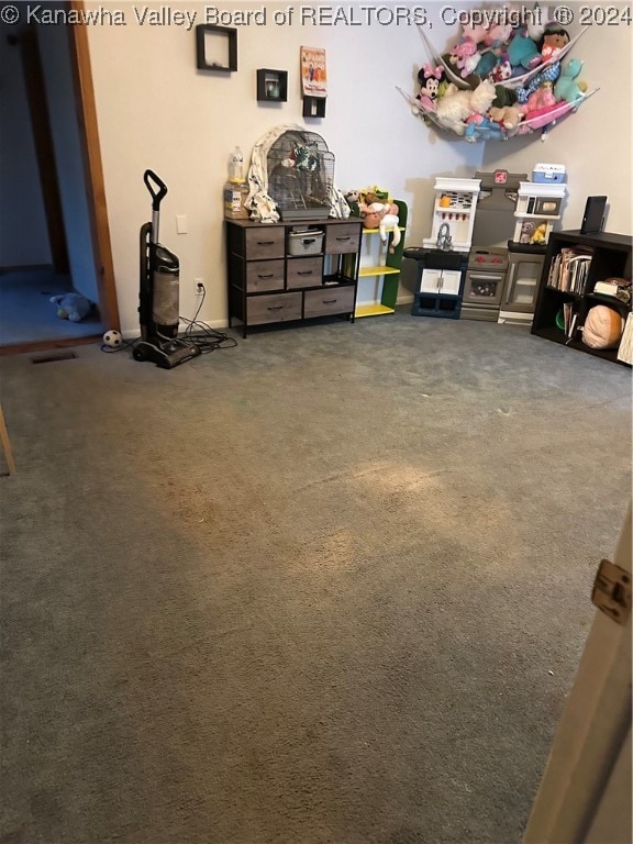 interior space featuring dark carpet