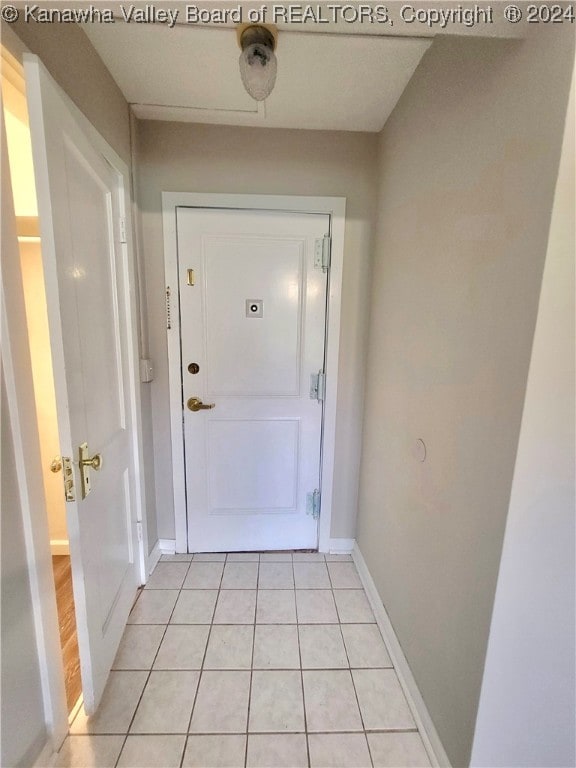 doorway with light tile patterned floors