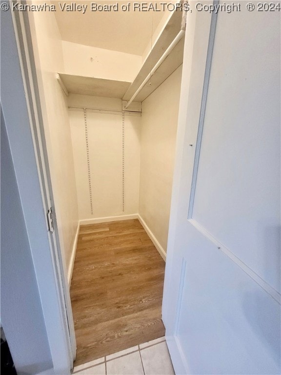 spacious closet with light hardwood / wood-style floors