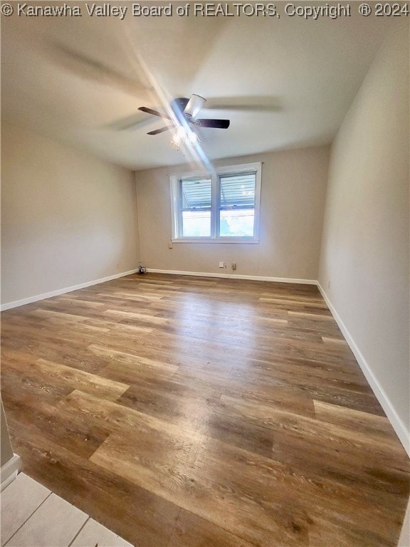 spare room featuring hardwood / wood-style flooring and ceiling fan