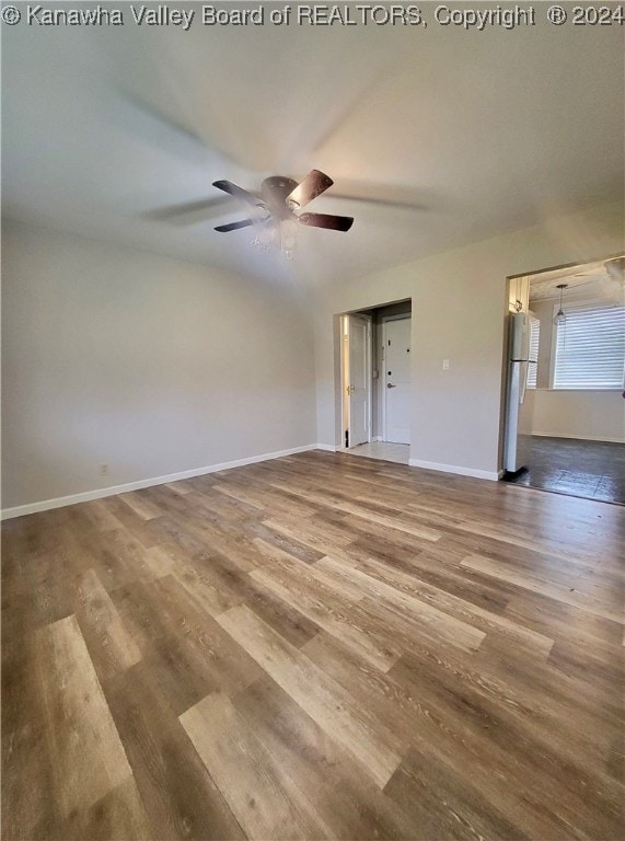 empty room featuring ceiling fan and hardwood / wood-style floors