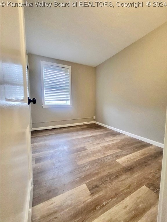 unfurnished room with wood-type flooring