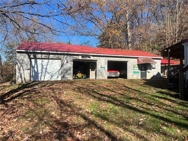 view of outdoor structure featuring a lawn and a garage