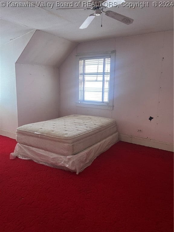 bedroom featuring ceiling fan, carpet floors, and lofted ceiling