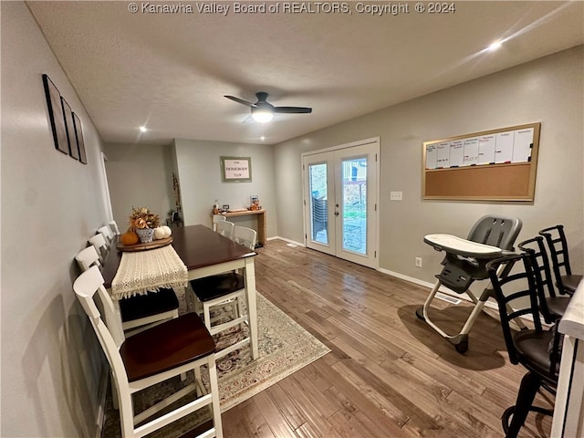 dining space with french doors, a textured ceiling, hardwood / wood-style flooring, and ceiling fan