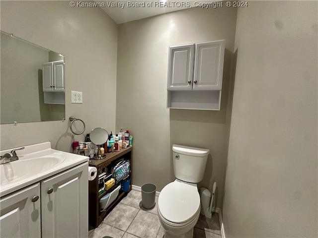 bathroom featuring toilet, vanity, and tile patterned floors