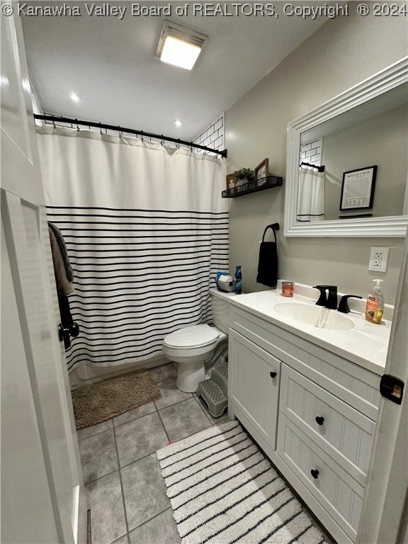 bathroom with toilet, vanity, tile patterned floors, and a shower with shower curtain