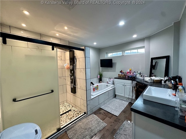 bathroom featuring shower with separate bathtub, vanity, and hardwood / wood-style flooring