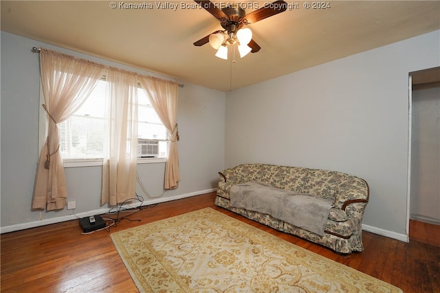 sitting room with hardwood / wood-style flooring, ceiling fan, and cooling unit