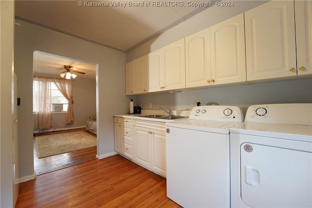 laundry room with cabinets, sink, ceiling fan, independent washer and dryer, and light wood-type flooring