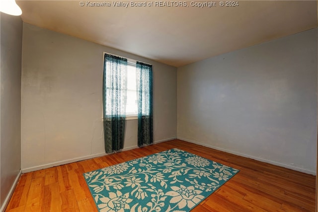 empty room with hardwood / wood-style flooring