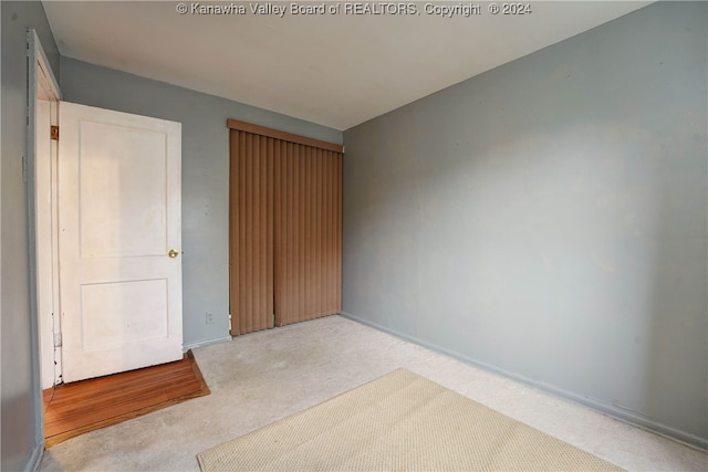 unfurnished bedroom with light colored carpet