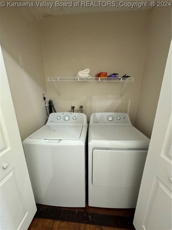 washroom featuring dark hardwood / wood-style flooring and washing machine and dryer