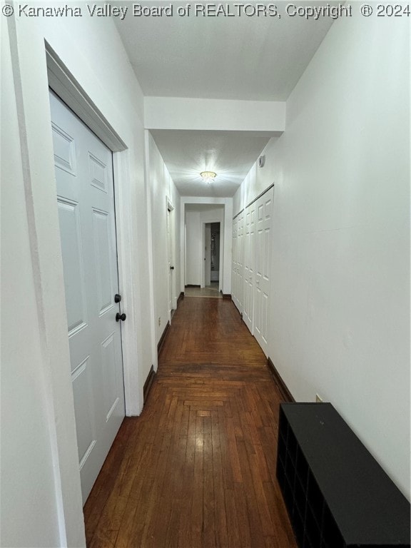 hallway with dark wood-type flooring