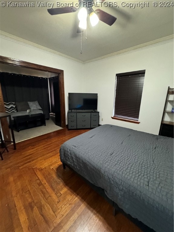 bedroom with wood-type flooring, ceiling fan, and crown molding