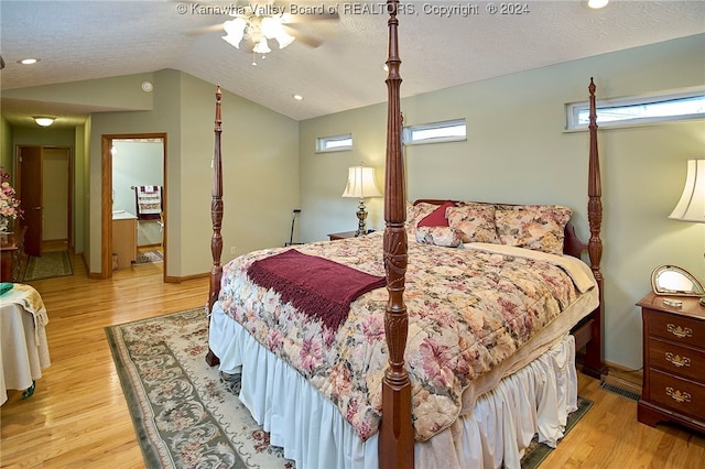 bedroom featuring a textured ceiling, light wood-type flooring, vaulted ceiling, and ceiling fan