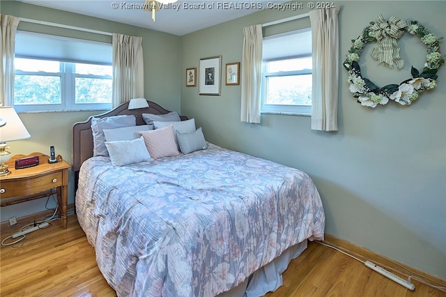 bedroom featuring hardwood / wood-style flooring and multiple windows