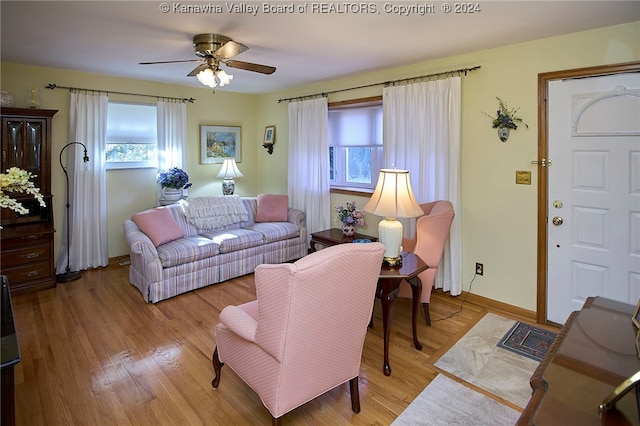 living room featuring ceiling fan and light wood-type flooring