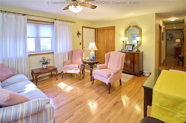 living area with light hardwood / wood-style flooring and ceiling fan