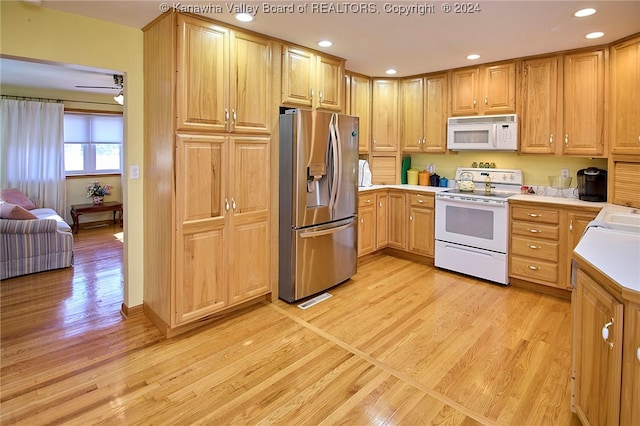 kitchen with ceiling fan, sink, light hardwood / wood-style floors, and white appliances