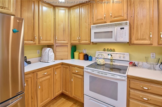 kitchen with light wood-type flooring and white appliances