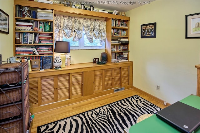 home office with hardwood / wood-style floors