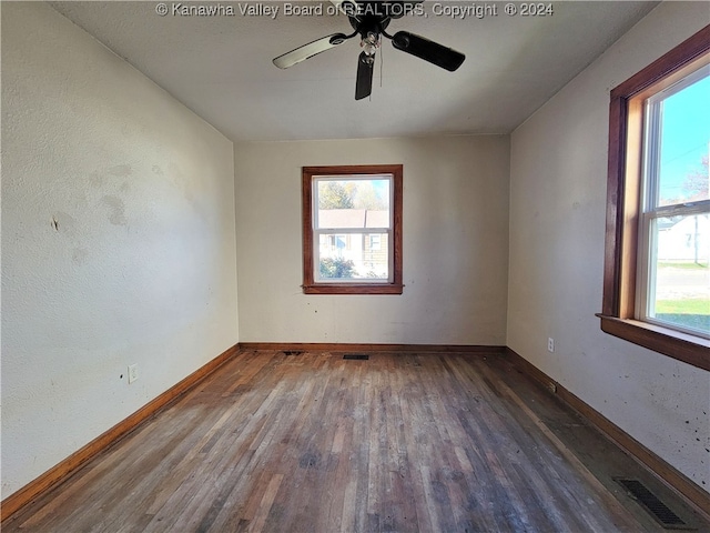 spare room with ceiling fan and dark wood-type flooring