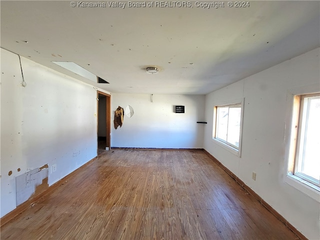 unfurnished room featuring hardwood / wood-style floors