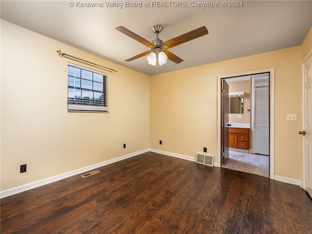 unfurnished bedroom featuring hardwood / wood-style floors, ceiling fan, and connected bathroom