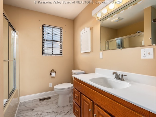 full bathroom featuring shower / bath combination with glass door, vanity, and toilet