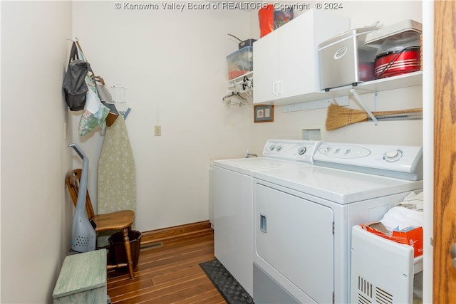 washroom featuring washer and clothes dryer, cabinets, and dark hardwood / wood-style floors