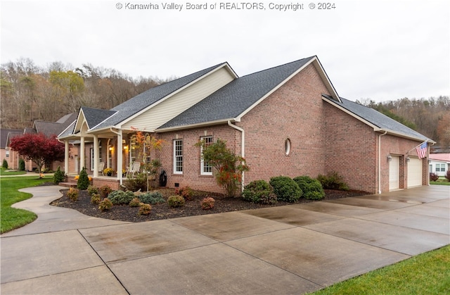 view of property exterior with a porch and a garage