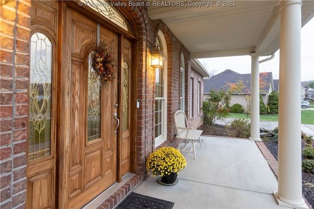 doorway to property featuring covered porch