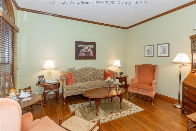 living room with hardwood / wood-style flooring and crown molding