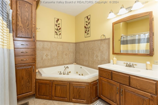 bathroom with tile patterned flooring, vanity, and a bathing tub