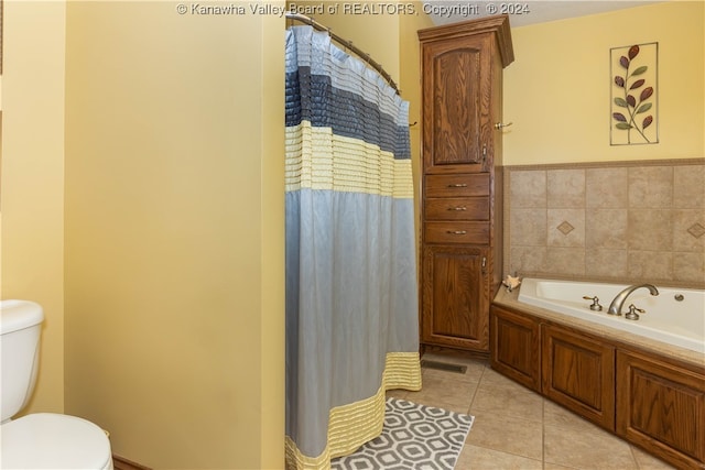 bathroom featuring tile patterned floors, toilet, and a bath