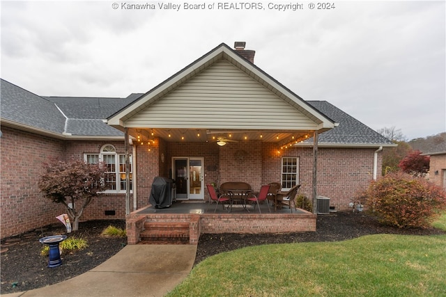 rear view of property featuring a patio area and a lawn