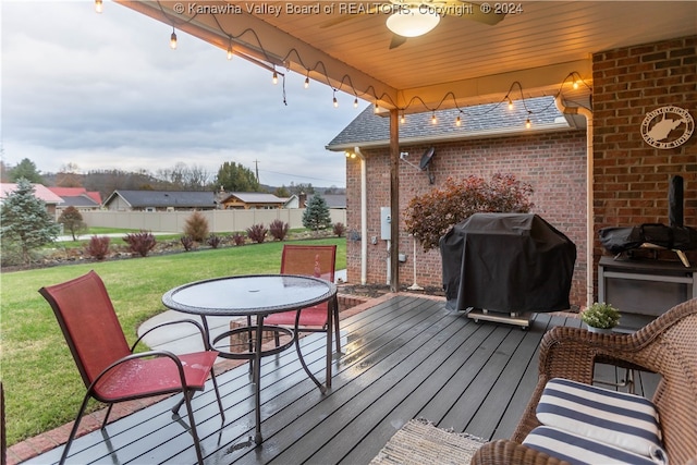 deck with area for grilling and a yard