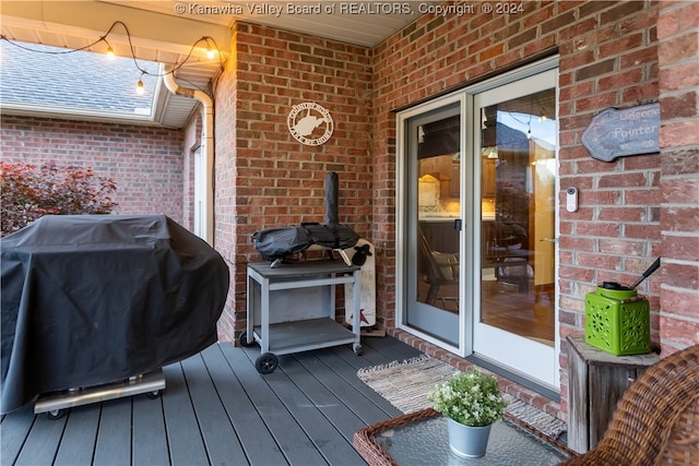 wooden deck featuring a grill