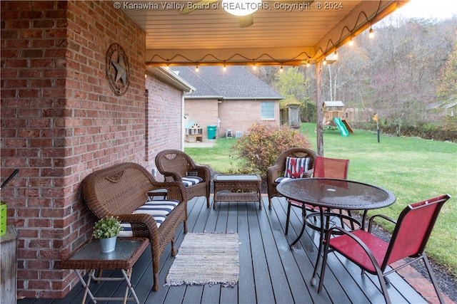 wooden deck featuring a lawn and a playground