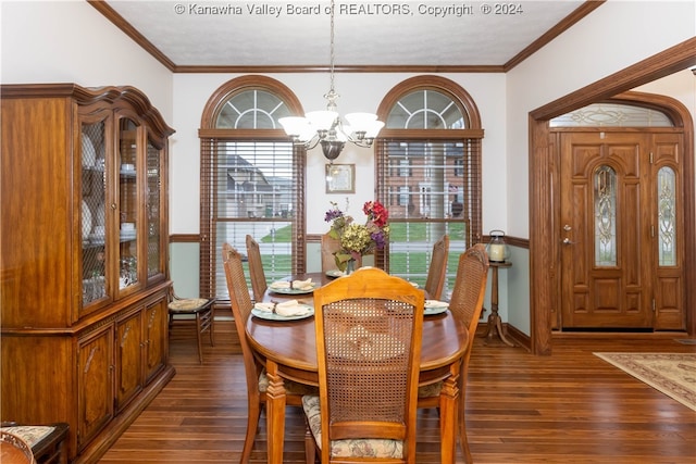 dining room with ornamental molding, dark hardwood / wood-style floors, and a notable chandelier