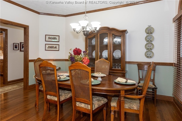 dining room with dark hardwood / wood-style flooring, crown molding, and an inviting chandelier