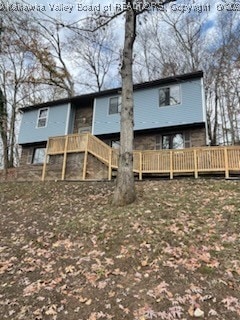 rear view of property with a wooden deck