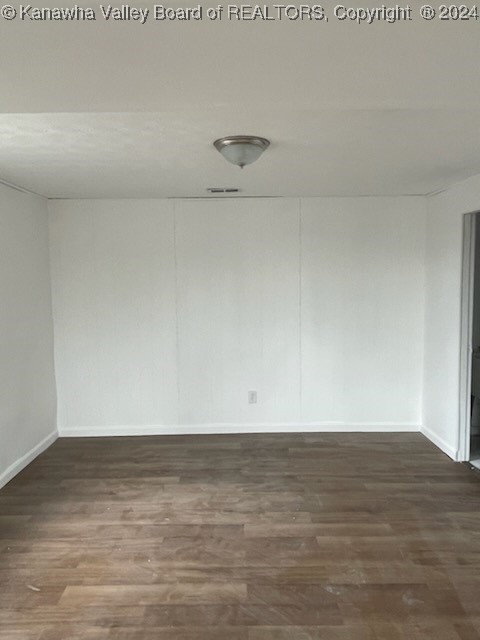 spare room featuring dark hardwood / wood-style floors